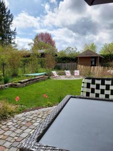 a pool in a backyard with a grass yard at Ferienhaus Landsberg in Landsberg am Lech