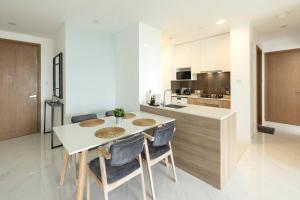 a kitchen with a table and chairs in a kitchen at Twin Peaks residence in Colombo
