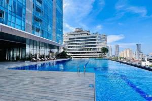 a large swimming pool in a city with buildings at Twin Peaks residence in Colombo