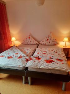 a bed with two pillows on it in a bedroom at Ferienwohnung Albus in Albertshausen