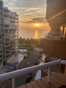 a view of a sunset from a balcony of a building at Apartamento Costa Marina 3 in El Borseral