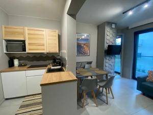 A kitchen or kitchenette at HELove Apartamenty