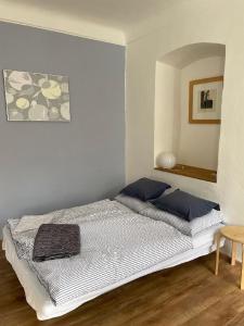 a bedroom with a bed with blue pillows on it at Apt. overlooking the castle Nižbor20km from Prague in Nižbor