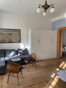 a living room with a couch and a table and chairs at Apt. overlooking the castle Nižbor20km from Prague in Nižbor
