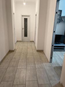 um corredor vazio com uma porta e um piso de azulejo em H&R's Room em Turim