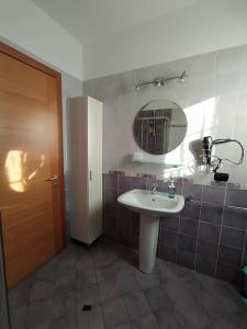 a bathroom with a sink and a mirror at La casa sul lago in  Monvalle 