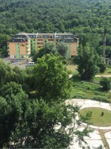 an apartment building in the middle of a park at Семеен Хотел Русалка in Svishtov