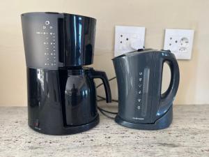 two black coffee pots sitting on a counter at Dolphins on Six Self Catering Apartments in Wilderness