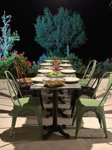 a long table with chairs and plates of food on it at Goknar Knidos Nature Hotel and Farm in Datca +66 photos