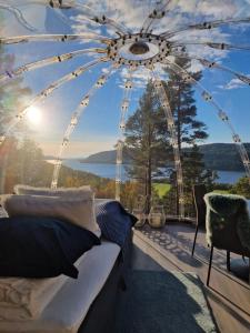 a bedroom with a view of a ferris wheel at Sørfjorden Eye Iglo - Fosen in Husby