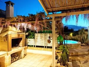 a patio with a fireplace and a swimming pool at Villa Anna Polignano in Polignano a Mare +19 photos