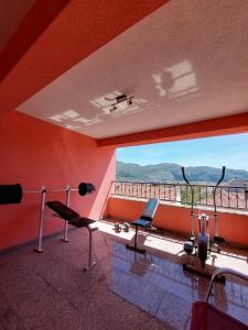 a room with two chairs and a balcony with a view at Apartment Andric 2 in Trebinje