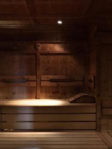 an empty sauna with the lights on in a room at Alpina Alpendorf in Sankt Johann im Pongau