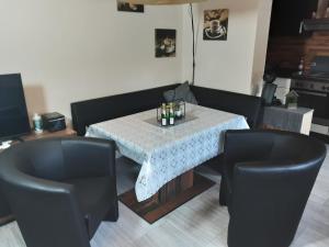 a dining room with a table and two chairs at Zum Goldenen Tal in Gräfendhron