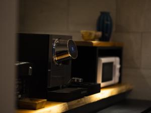 a coffee maker on a counter next to a microwave at Higashiyama Hills in Kyoto