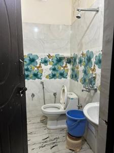 a bathroom with a toilet and a sink at Hotel Blue Star in Haldwāni