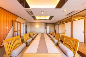 a long conference room with a long table and chairs at 銚子グランドホテル in Choshi +61 photos
