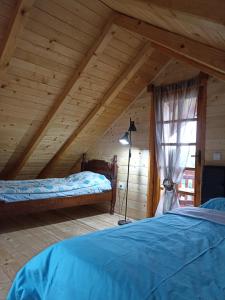 a attic room with two beds and a window at Bellavista 