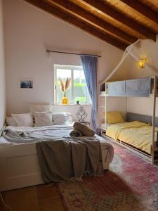 a bedroom with two beds and a window at Casa Ensolarada B&B and Pottery in Aljezur