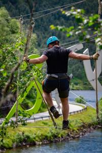 a man on a rope bridge over the water at Sirdal fjellpark in Tjørhom
