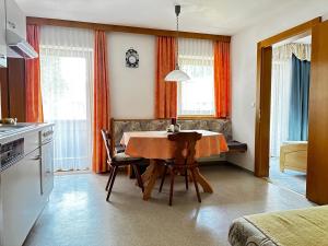 a kitchen with a table and chairs in a room at Haus Luxer in Auffach