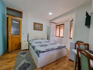 a bedroom with a bed and a wooden floor at Gurman in Strumica