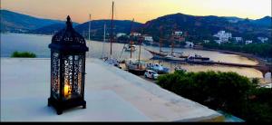 a lantern sitting on top of a building near a harbor at Apanemo in Grikos