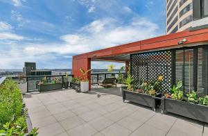 a patio with flowers and plants on a building at City and view holiday home in Auckland