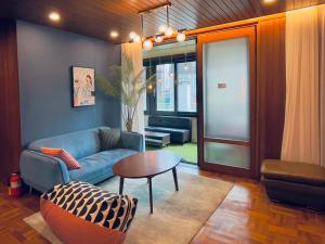 a living room with a couch and a table at OYO Hostel Myeongdong 5 in Seoul