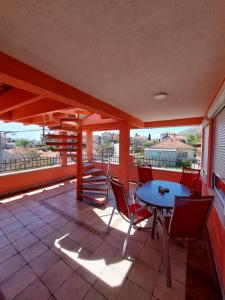 a patio with a table and chairs on a balcony at Apartment Andric 2 in Trebinje