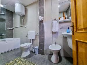 a bathroom with a toilet and a sink at Gurman in Strumica +57 photos