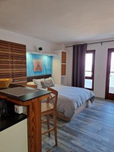 a bedroom with a bed and a table in it at Apartamentos Wundermar in Torredembarra
