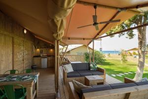 a large patio with a couch and a table at LOGOS Beach Village in Theologos