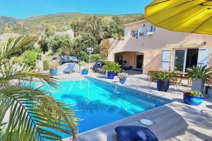 a villa with a swimming pool and a house at Maison Partina avec Piscine in Santa-Maria-di-Lota