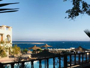 a view of a beach with umbrellas and the ocean at Sunny Dahab Resort Family Deluxe in Dahab