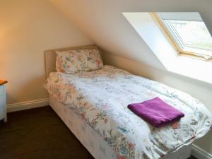 a small bed in a room with a window at Swans Nest - Uk43545 in Belford