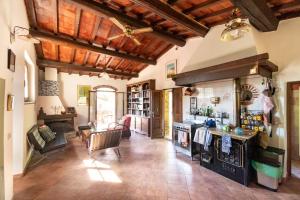 a large kitchen with wooden ceilings and a stove at Tuscan Countryside Paradise with Pool in Cavriglia