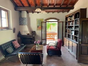 a living room with a couch and a table at Tuscan Countryside Paradise with Pool in Cavriglia