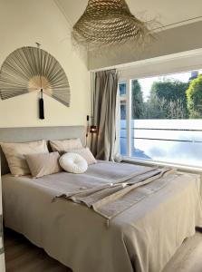 a bedroom with a large bed with a large window at Kranenbergh Boutique Apartments in Bergen