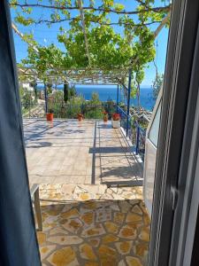 a view of a patio from the door of a house at Ionian View Guest House in Qeparo