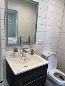 a bathroom with a sink and a toilet at 3 bedroom apartment in Newmarket in Auckland