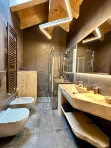 uma casa de banho com um WC, um lavatório e uma banheira em Al Bait Del Legn 5 em Bormio