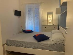 a bedroom with a bed with two pillows on it at Pennino studios Bacoli in Bacoli