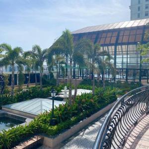 a building with palm trees in front of a building at Happiest Homestay 2 - Manor Crown Hue in Thôn Trường Giang