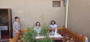 a group of three women sitting around a table at Guest House Art Postindoz in Khiva