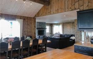 a living room with a table and a fireplace at Awesome Home In Geilo With Sauna in Skoro