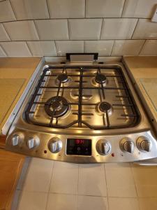 a stove top oven in a kitchen at London Luxury 6 Bedroom Family House Sleeps 12 people Parking for 4 Cars Close to tube. in Chigwell
