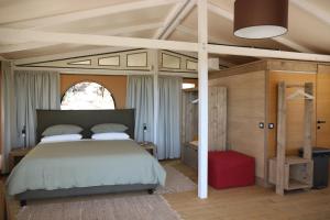 a bedroom with a large bed in a room at Glamping La Ghianda in Elmo