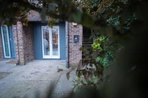 una puerta delantera de una casa de ladrillo con una puerta azul en Home to home studio flat - only 6 minutes to centre - perfect for contractors working in and around Nottingham, en Nottingham