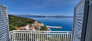 a view of a body of water from a balcony at Apartmani ANCORA, Crkvice in Kuna Pelješka